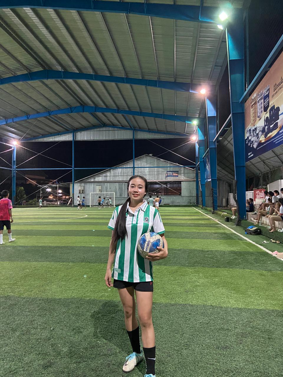 Dokkham sur un terrain de football, ballon à la main