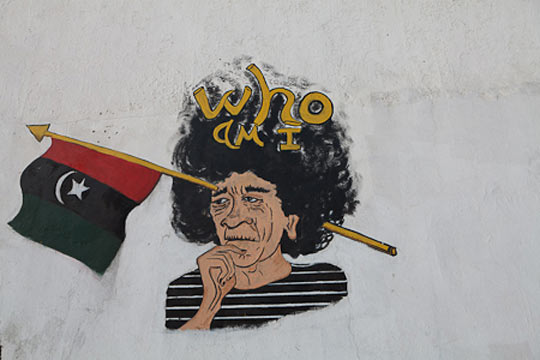 //“Who am I” – a phrase alluding to Gaddafi’s infamous February 22 speech in which he asked the Libyan people “Min entum?”, “Who are you?”