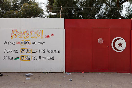 //A Benghazi wall shows what big inspirations Tunisia and Egypt were to the Libyan revolution.