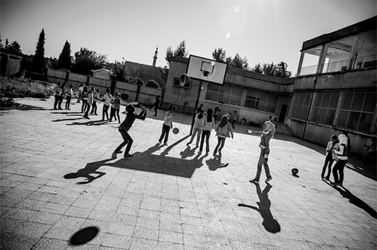 //A normal scene in a schoolyard in al-Malikiyah (Derek in Kurdish), al-Hasaka Governorate, Syria, where life goes on as usual since there has been little fighting in this region of Syria. Photo by Andy Spyra.