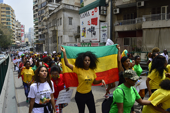 //Ethiopian migrant workers hold up the Ethiopian flag at the annual Migrant Workers' March in Beirut (Anti-Racism Movement)