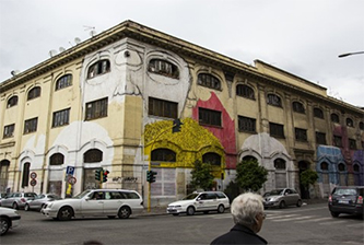 //A work by Blu, on the walls of former barracks on Porto Fluviale street, in Ostiense, Rome.